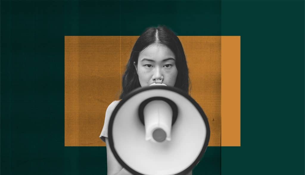 An Asian person with long hair stands holding a white megaphone towards the camera; their face is blurred for privacy, set against an orange rectangle and dark teal background.