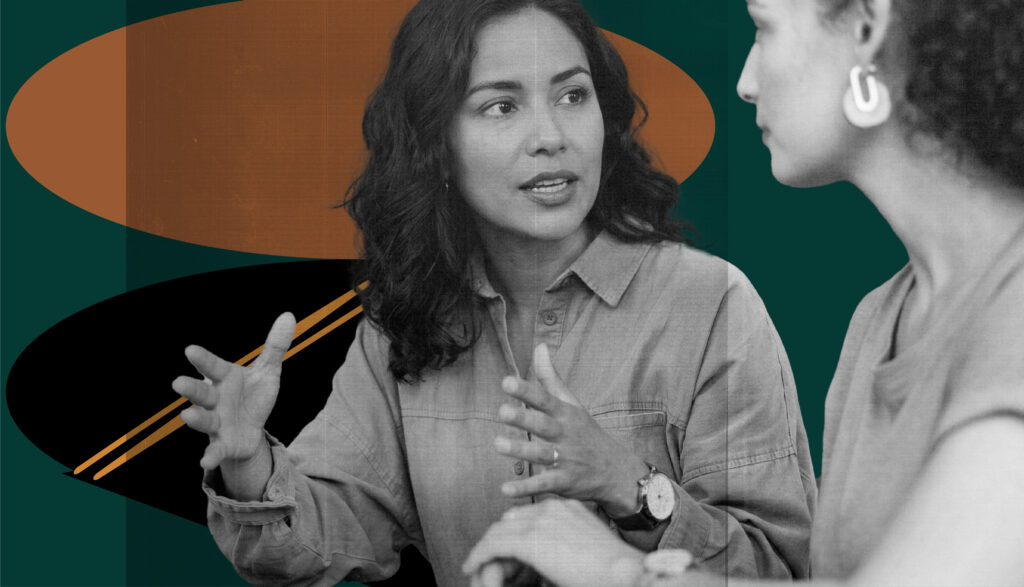 A black-and-white photograph of two feminine-presenting people in conversation, with one gesturing expressively while speaking to the other. the image is overlaid on a modern graphic background consisting of dark teal, orange, and black organic shapes with two diagonal gold lines.